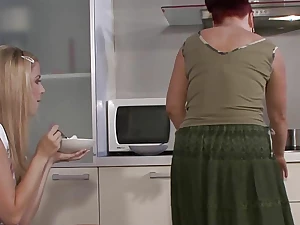 Mom and lesbian teen have fun on the kitchen